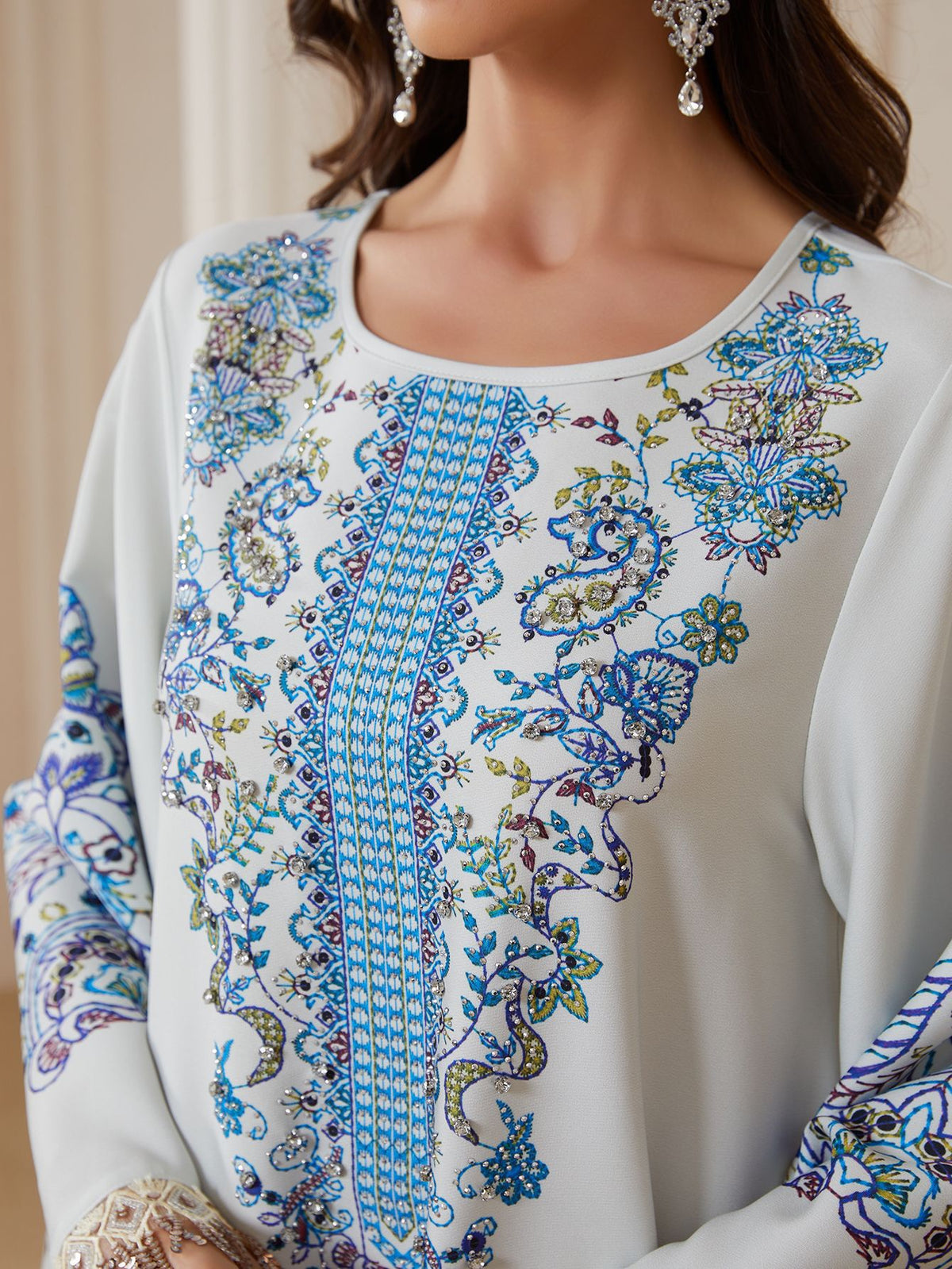 Close-up of rhinestone embellished blue floral print on abaya chest